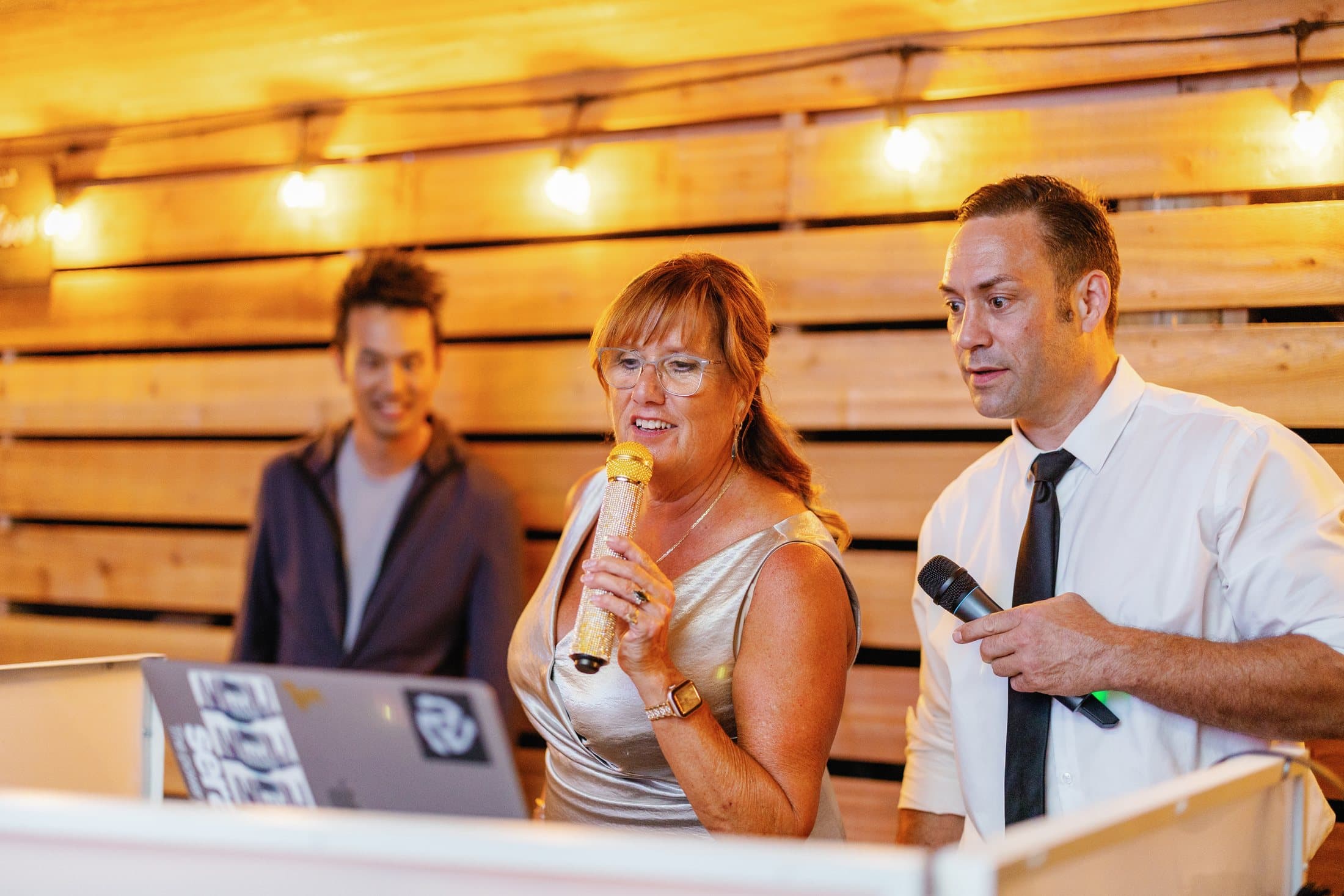 Guests cracking up during a hosted wedding game