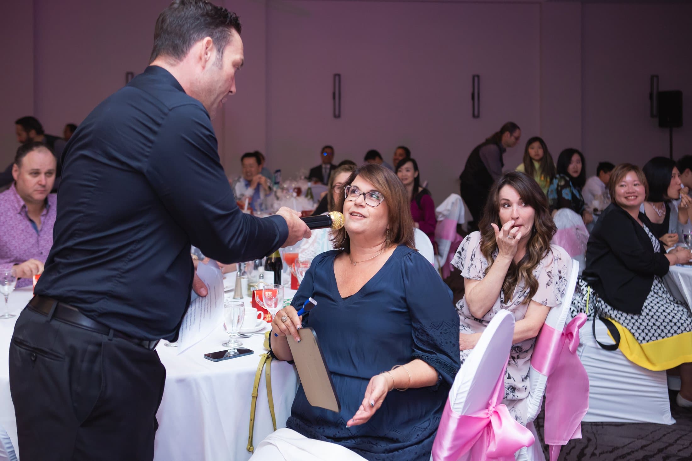 Mike Oulton working a table of guests mid-reception