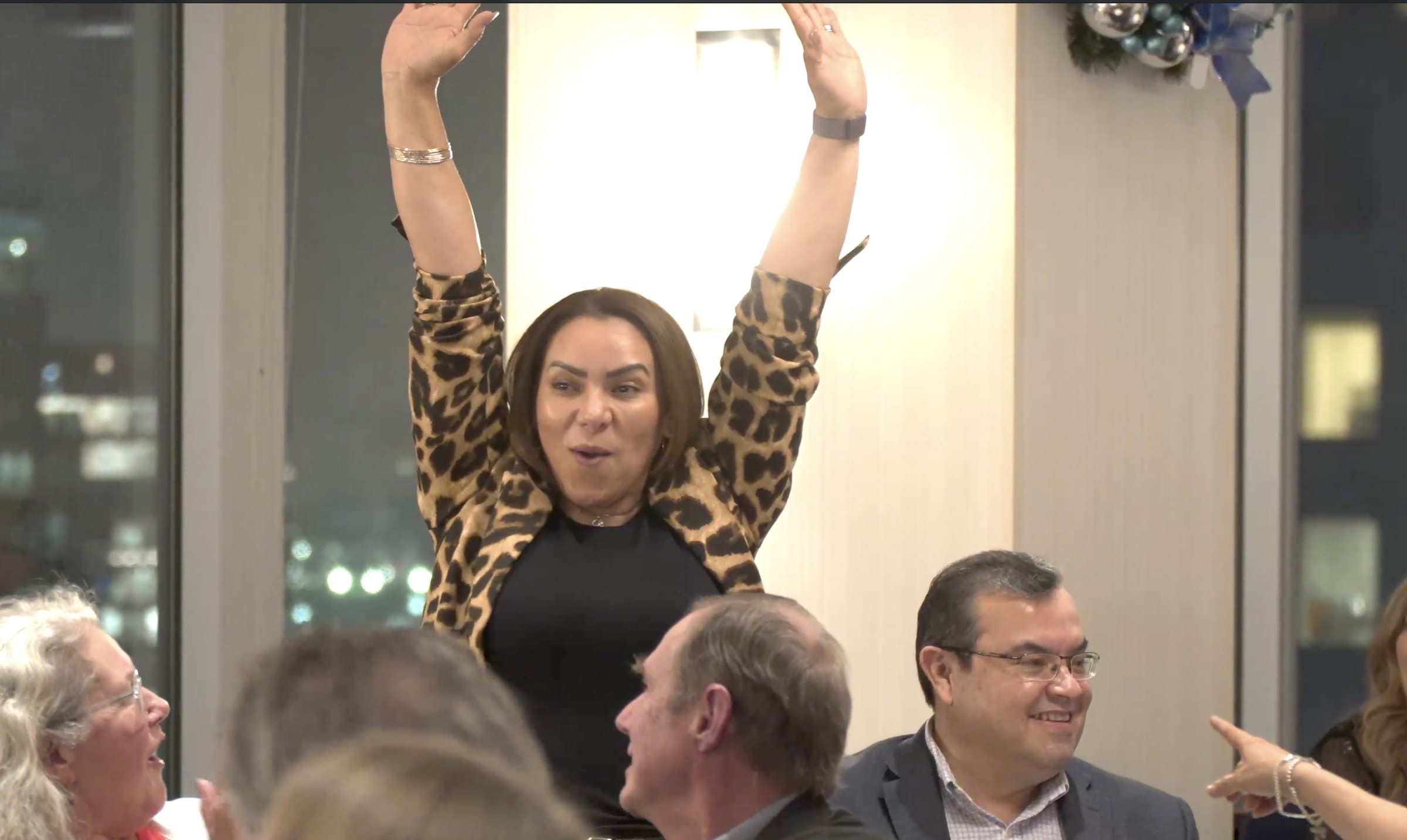 Colleagues laughing with their hands up during a hosted corporate event in Vancouver