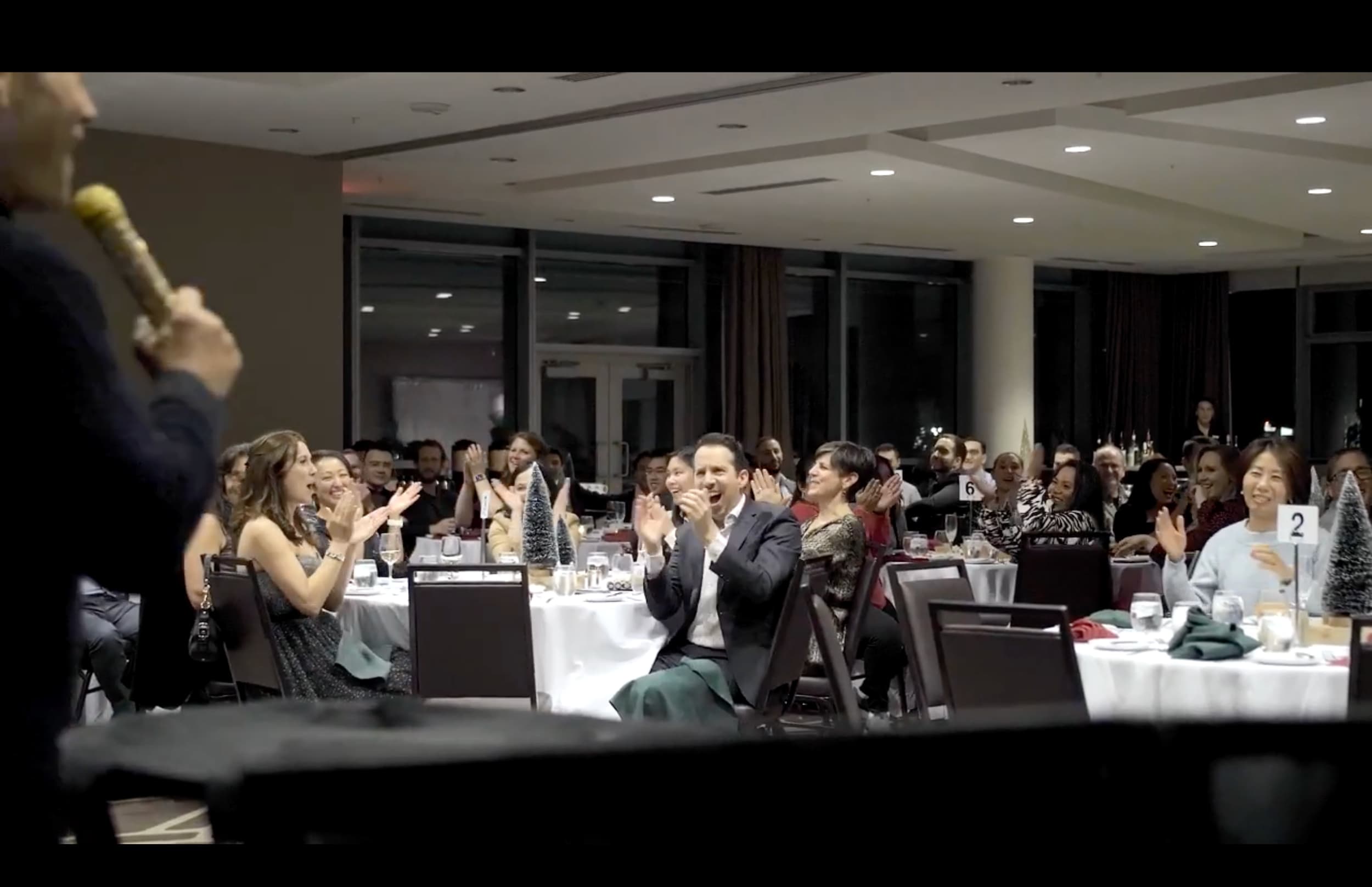 A corporate awards night in Vancouver, guests applauding at their tables