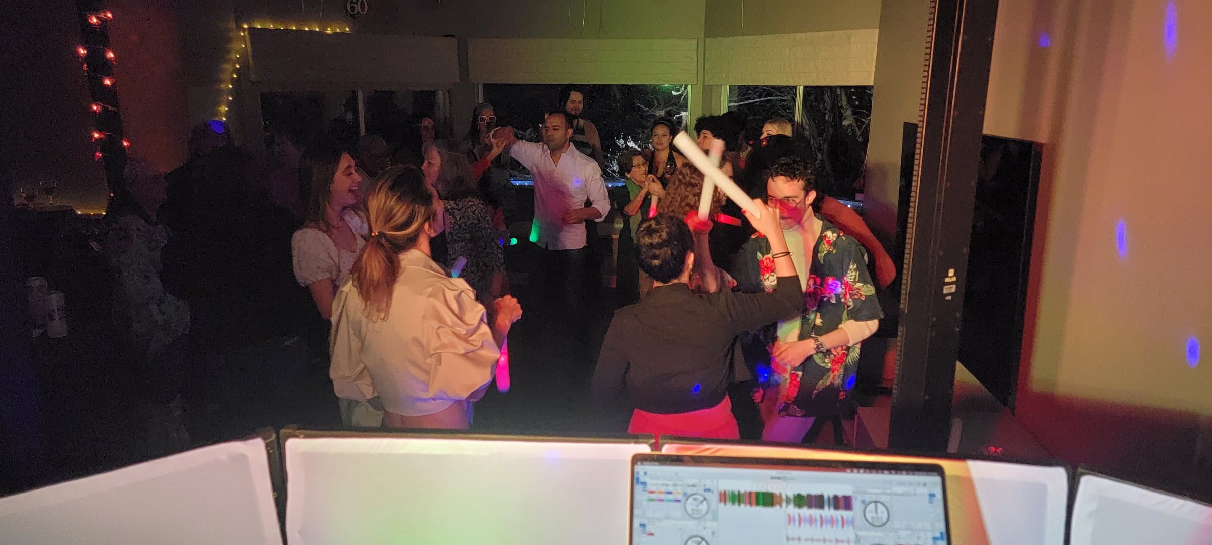 A packed dance floor in Vancouver seen from behind the DJ booth