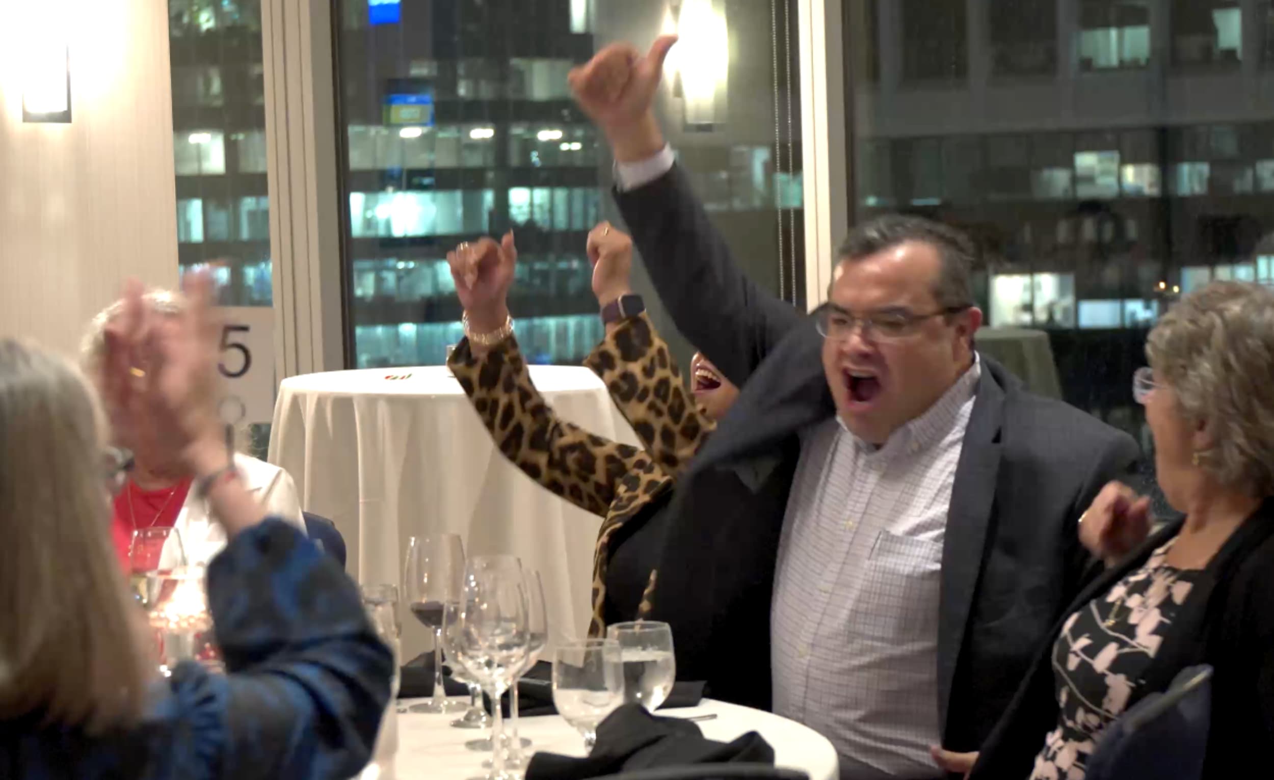 A crowd cheering during a hosted event moment