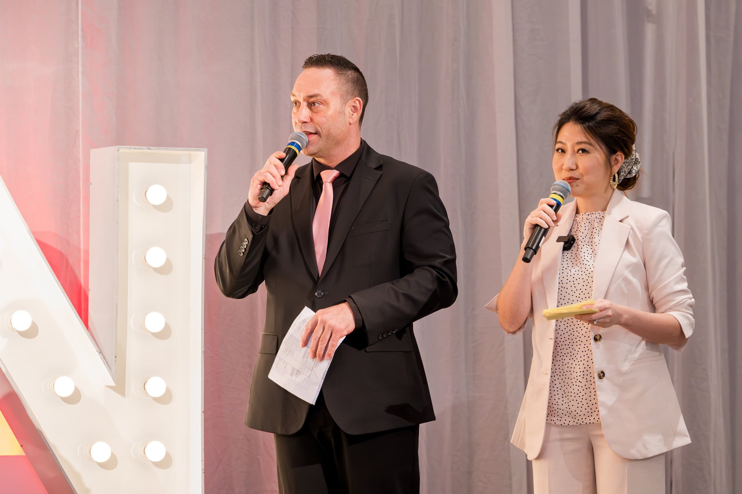 Mike Oulton speaking on stage at a live corporate gala in Vancouver