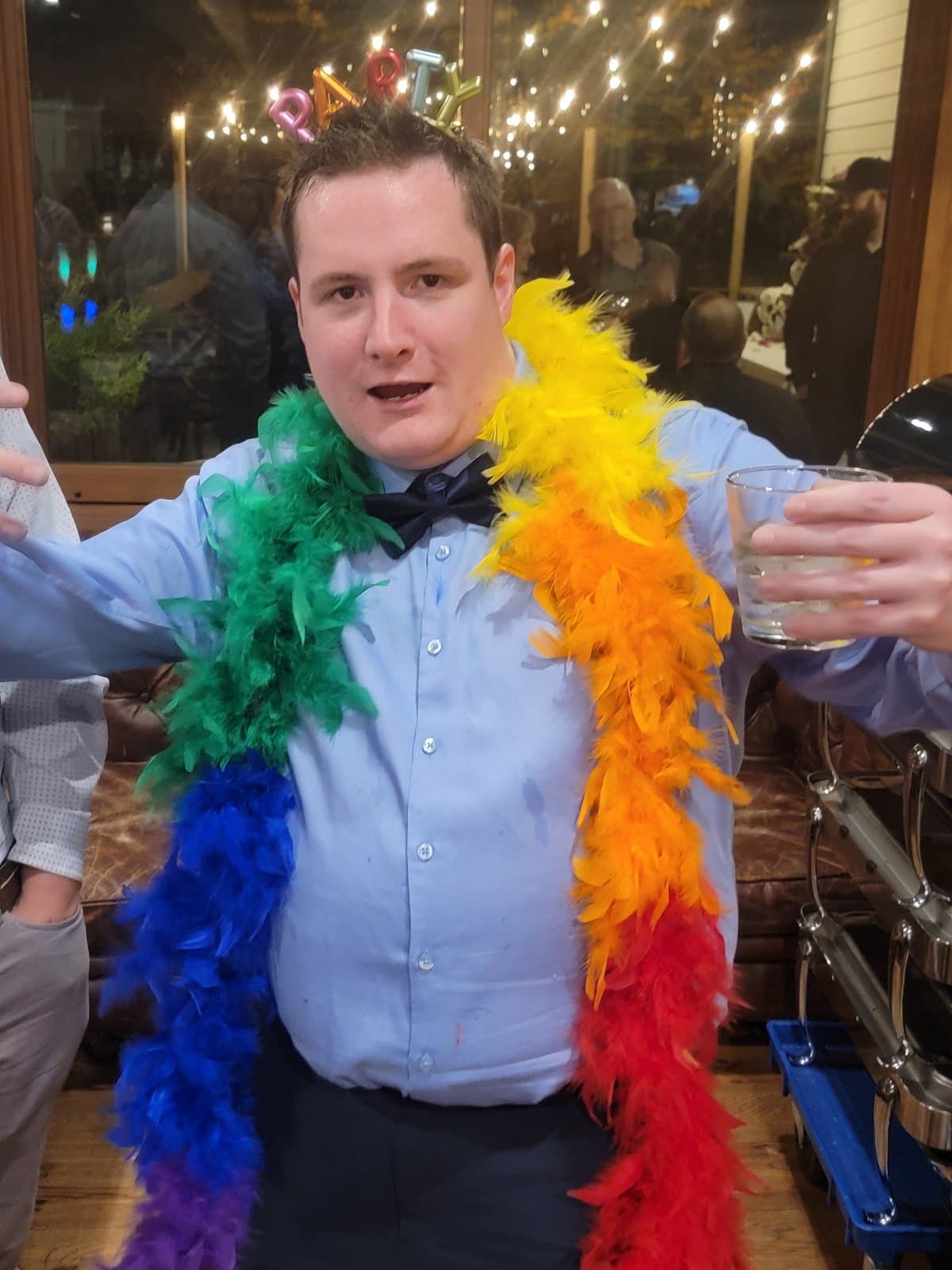 A guest in a feather boa mid-celebration at a Vancouver party