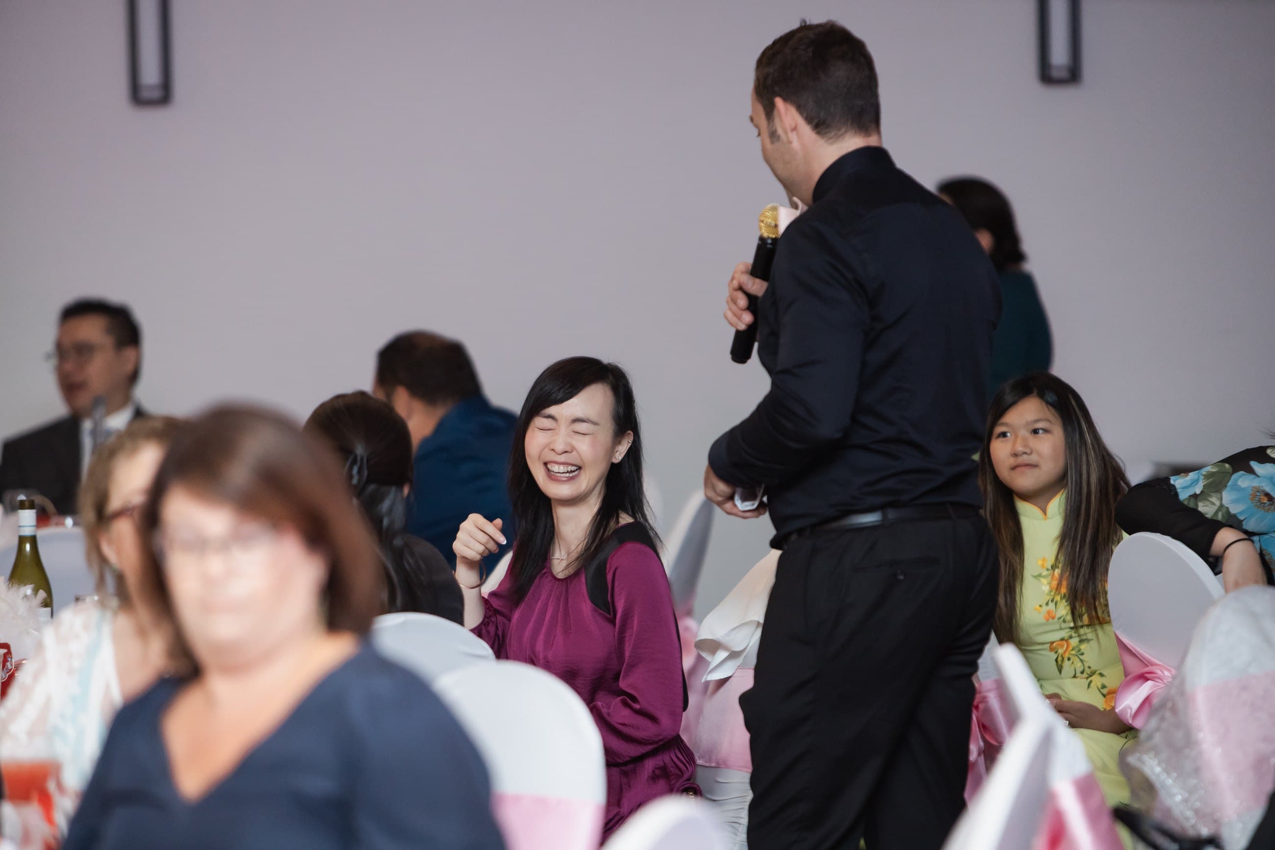 Wedding guests laughing at their table